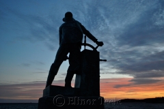 Man at the Wheel at Sunset
